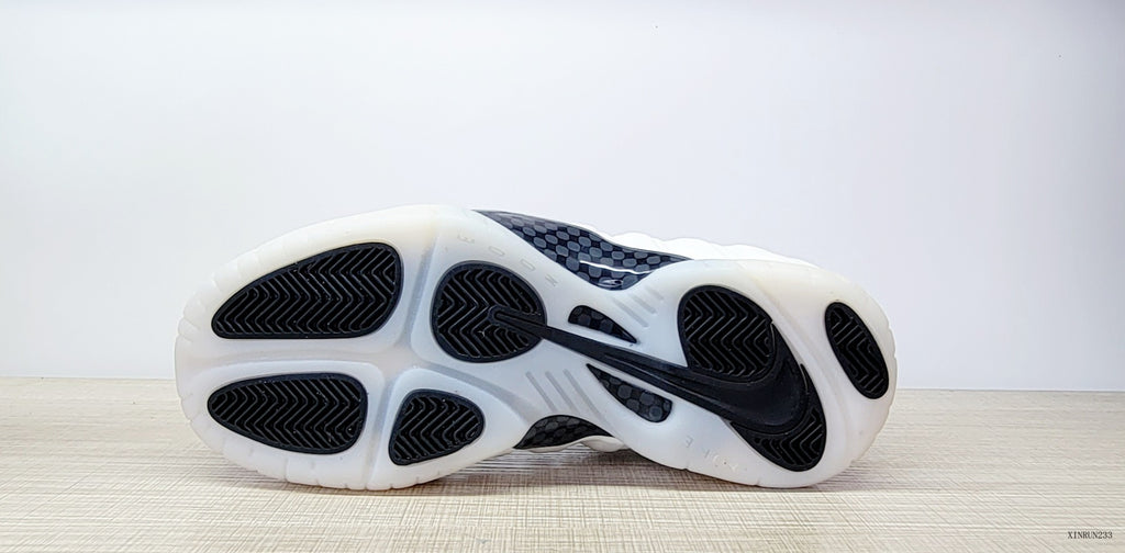 Outsole view of a Nike Air Foamposite One sneaker with black traction sections