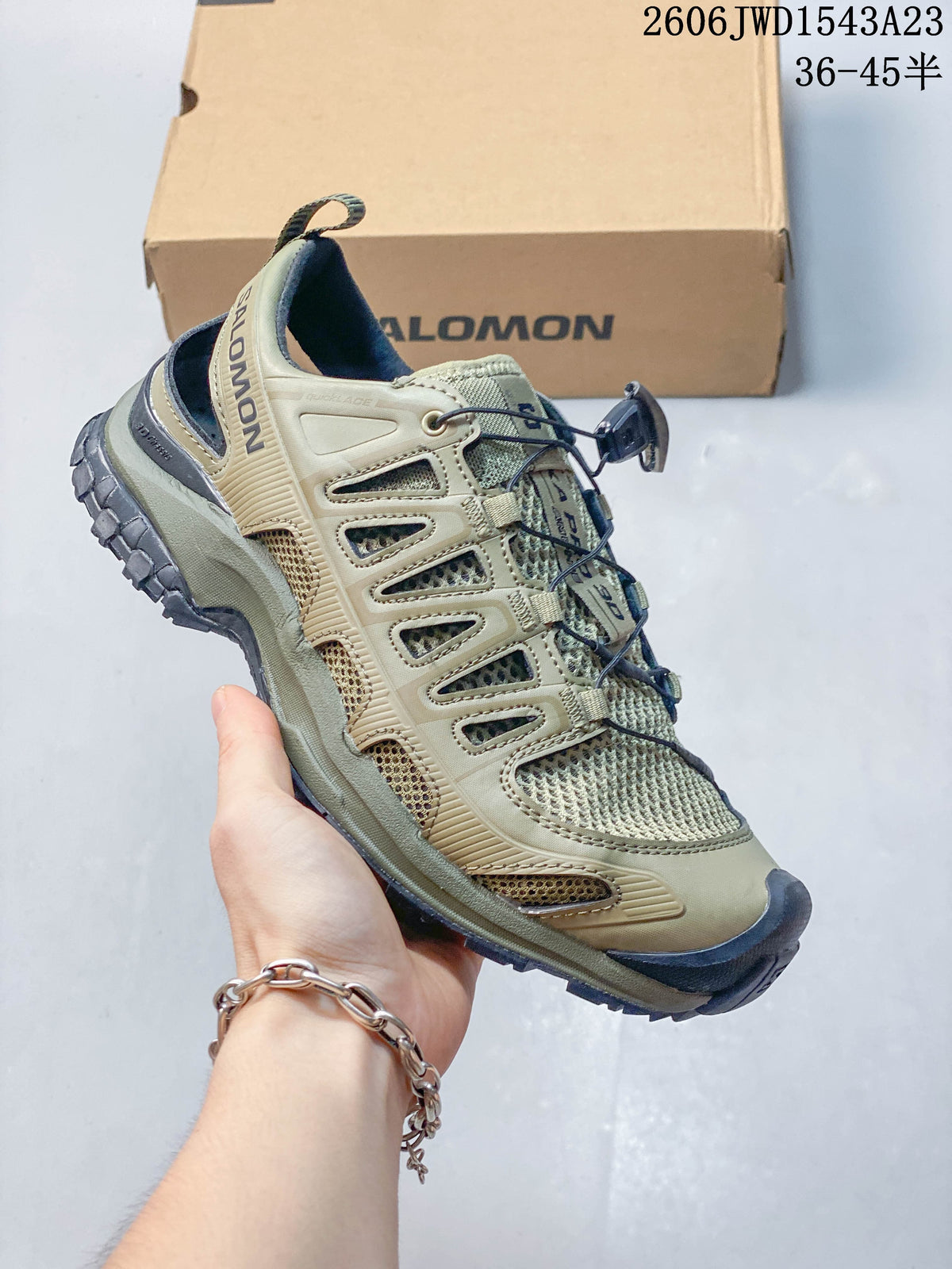 Side view of the shoe showing the olive upper, mesh panels, and dark outsole