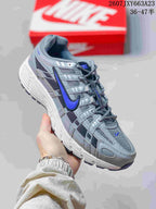 Angled side view of the gray and blue Nike P-6000 sneaker with contrasting blue branding.