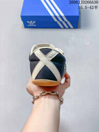 Heel view showing crossed cream bands on the navy sneaker