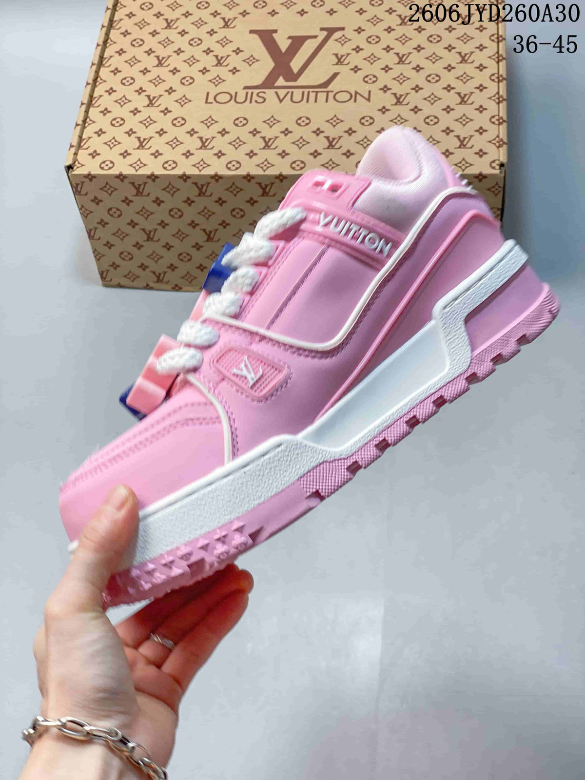 Side view of the pink low-top Trainer Maxi sneaker with white trim and a chunky outsole.