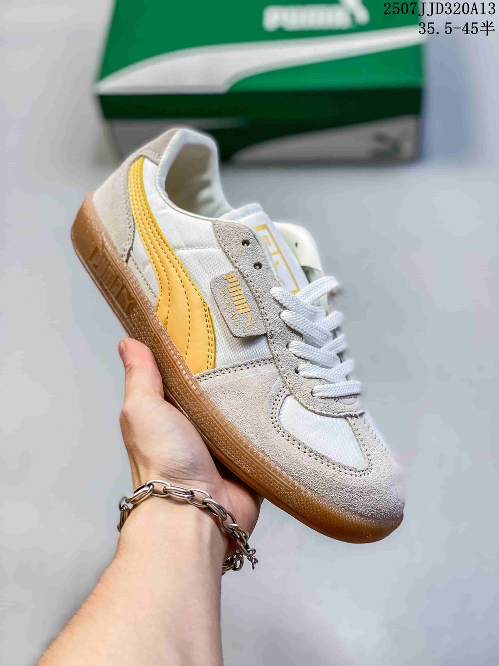 Angled side view showing the yellow PUMA side stripe, lace-up construction, and gum outsole.