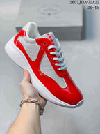 Red and white Prada America's Cup low-top sneaker with glossy red overlays and white laces.