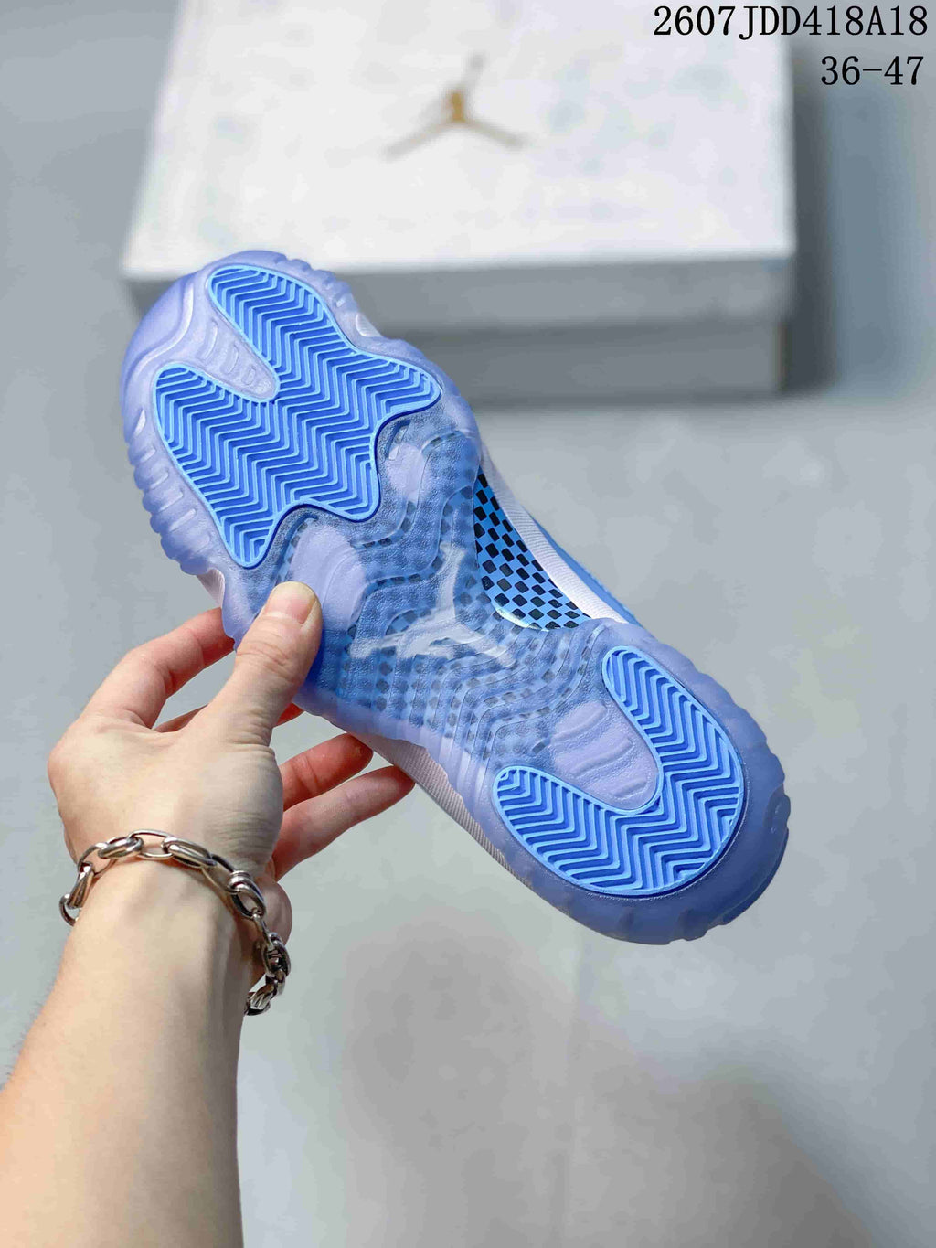 Underside view showing the translucent blue outsole and patterned traction areas of a Jordan high-top sneaker.