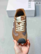 Top view showing the rounded toe, cream laces, brown overlays, and gray central panels.
