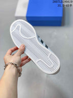 Close-up of the white textured outsole of an adidas Superstar sneaker with a zigzag tread pattern.