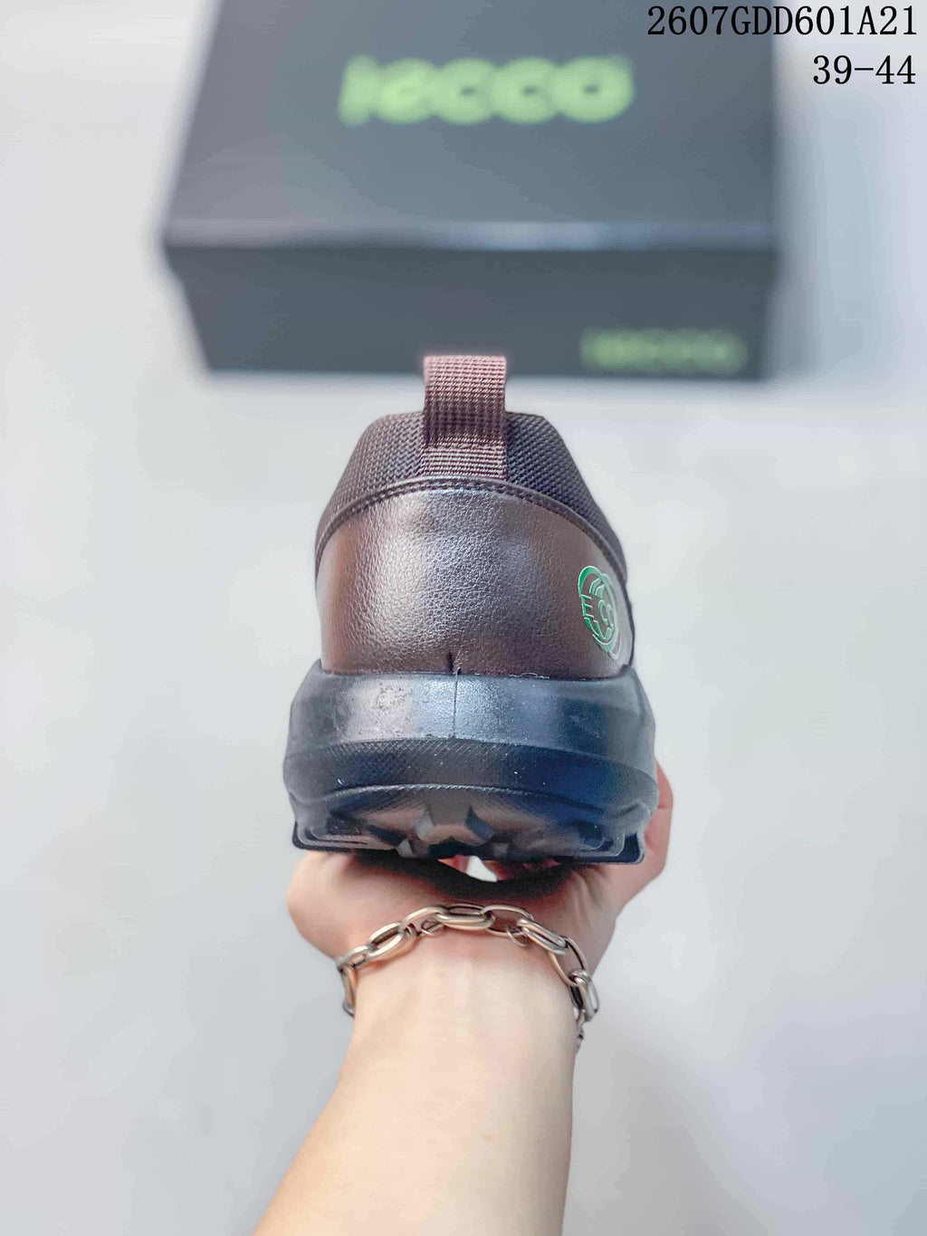 Rear view of the brown ECCO shoe showing the heel pull tab, heel logo detail, and black outsole.