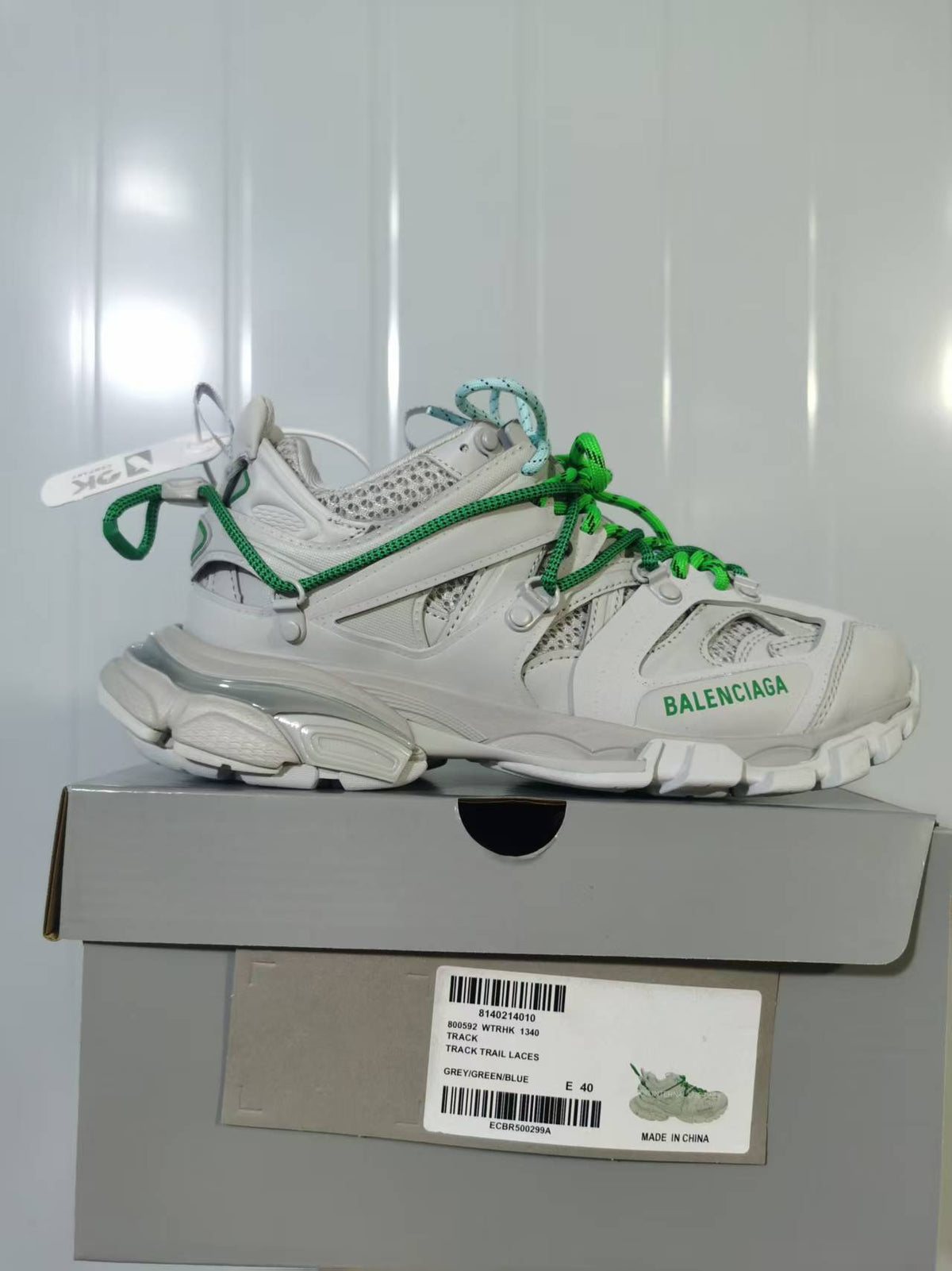 Balenciaga Track Trail sneaker in grey, green and blue shown on its box, with the size label visible.