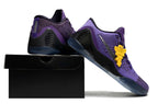 Purple shoes displayed on a black shoebox.