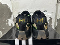 Rear view of black BAPE STA sneakers with camouflage panels and gold tongue branding.