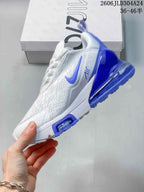 Side profile of a white Nike Air Max 270 sneaker with blue accents and a transparent heel unit.