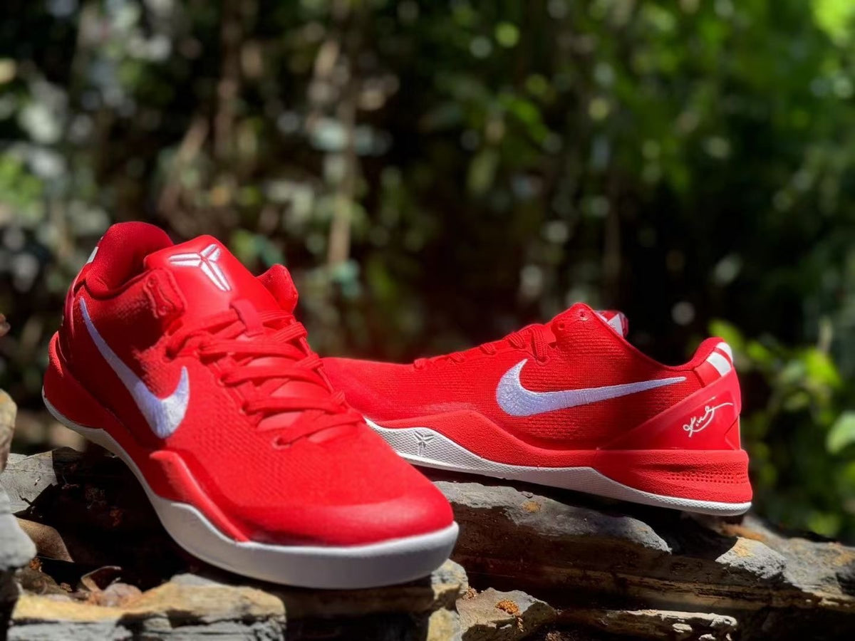 Pair of red Nike Kobe 8 basketball shoes photographed from the front and side