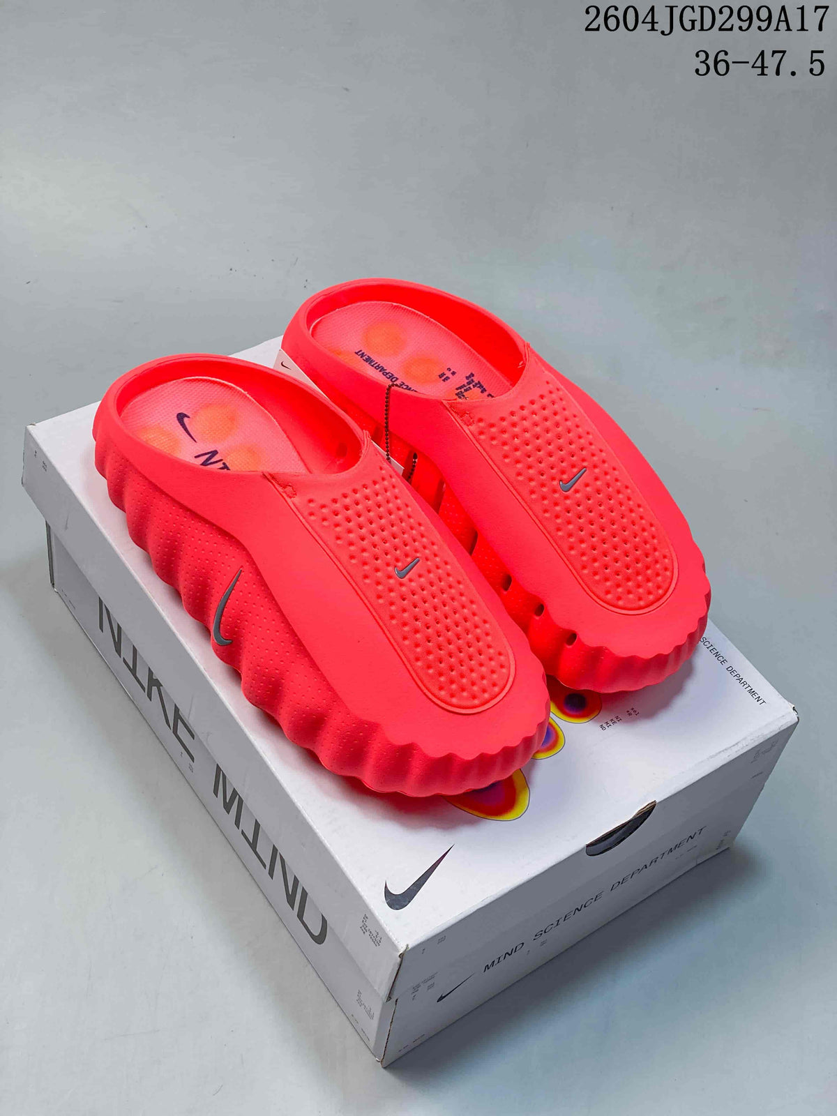 Pair of red Nike Mind 001 slides displayed on a Nike Mind shoebox.