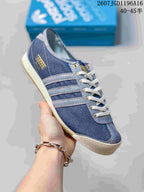 Side view of a blue adidas Spezial sneaker showing the contrasting stripes, heel branding and cream rubber outsole.