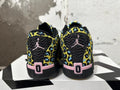 Rear view of black Jordan Luka 1 shoes with yellow and blue patterned panels and pink heel details