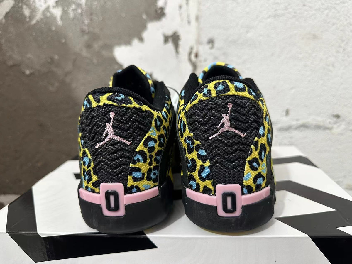 Rear view of black Jordan Luka 1 shoes with yellow and blue patterned panels and pink heel details