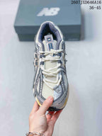 Top view of a New Balance 1906A sneaker showing the mesh toe box, white laces, padded collar, and tongue branding.