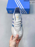 Top view showing the white laces, branded tongue, blue collar lining, and layered toe panels.