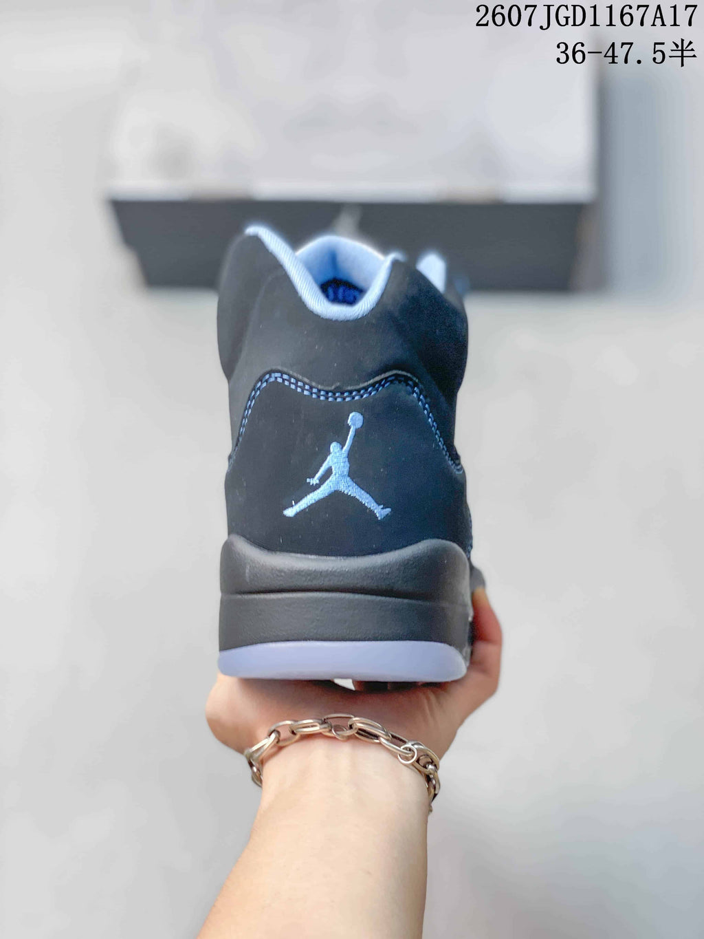 Rear view of the black high-top sneaker showing the Jordan logo on the heel and translucent outsole sections.