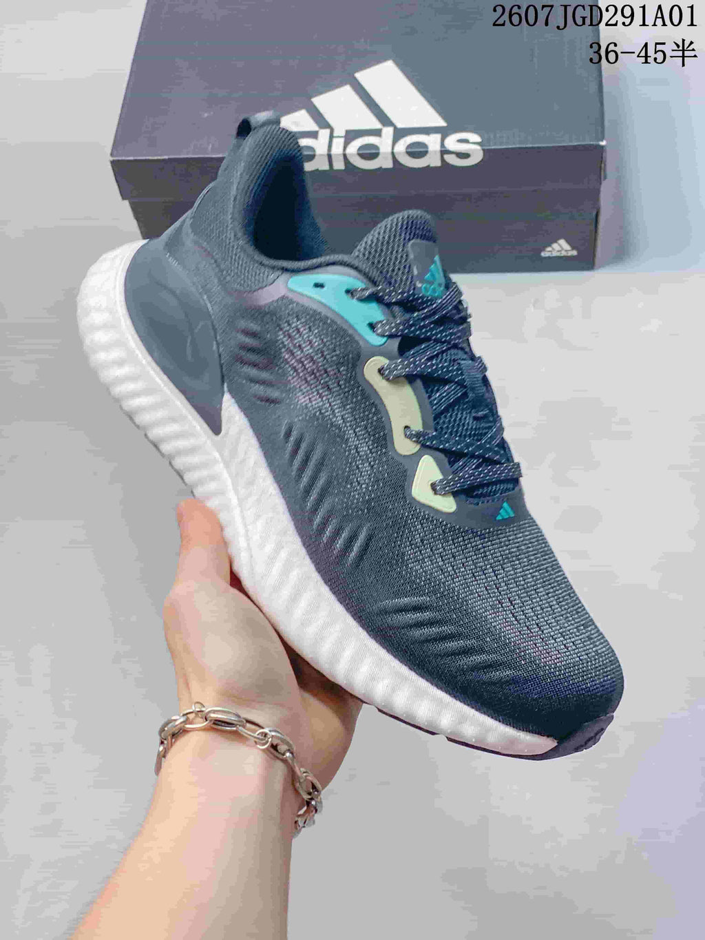 Close side view of the navy sneaker, with teal detailing and a white midsole.