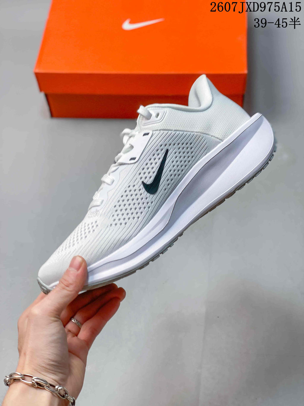 Side view of a white Nike Quest 6 sneaker with black Swoosh branding and a raised white midsole.