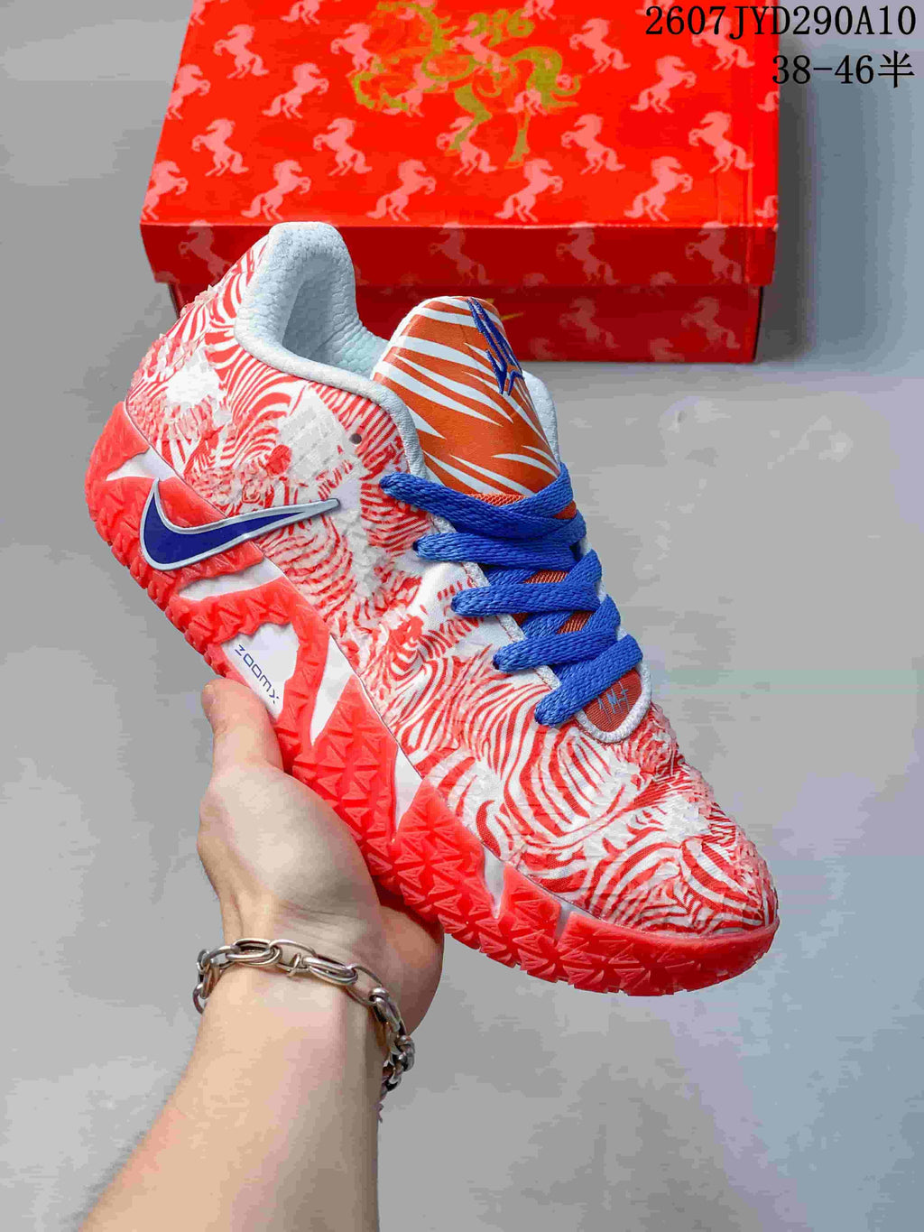 White and red Nike Ja 3 shoe with red horse-themed graphics, blue laces, and an orange striped tongue panel.