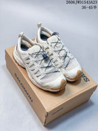 Pair of ivory Salomon XA Pro 3D Amphib low-top sneakers on a shoe box