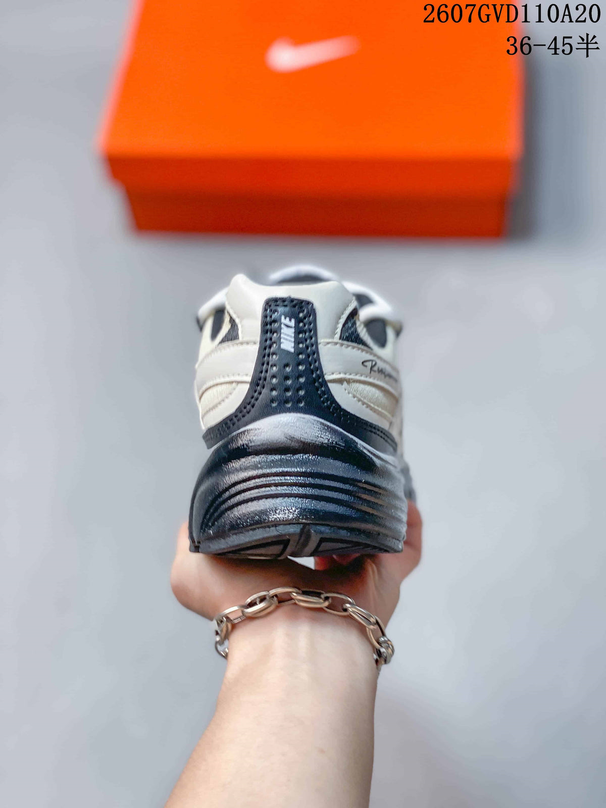 Rear view of the sneaker showing the padded heel, dark heel overlay, layered midsole, and textured outsole.