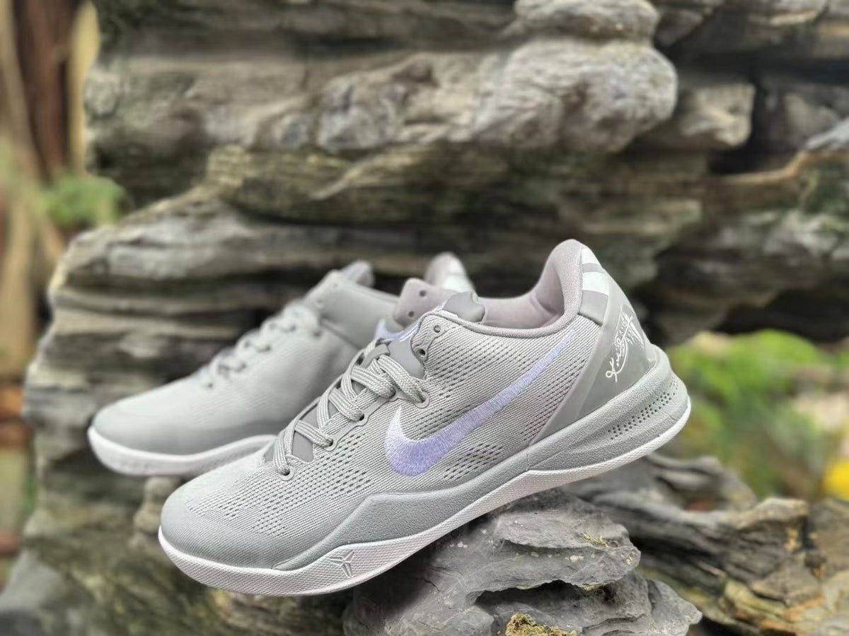 Angled close-up of Wolf Grey Nike Kobe 8 shoes with laces and side logos visible