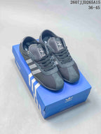 Black adidas Originals Tokyo low-top sneakers with light gray three-stripe detailing, displayed on a blue adidas shoebox; the image shows the size range 36–45 and code 2607JJD265A15.