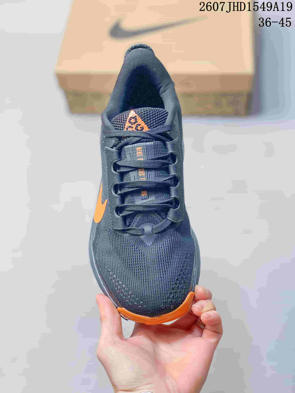 Top view showing the lace-up design, dark gray mesh-textured upper, and orange toe accent.