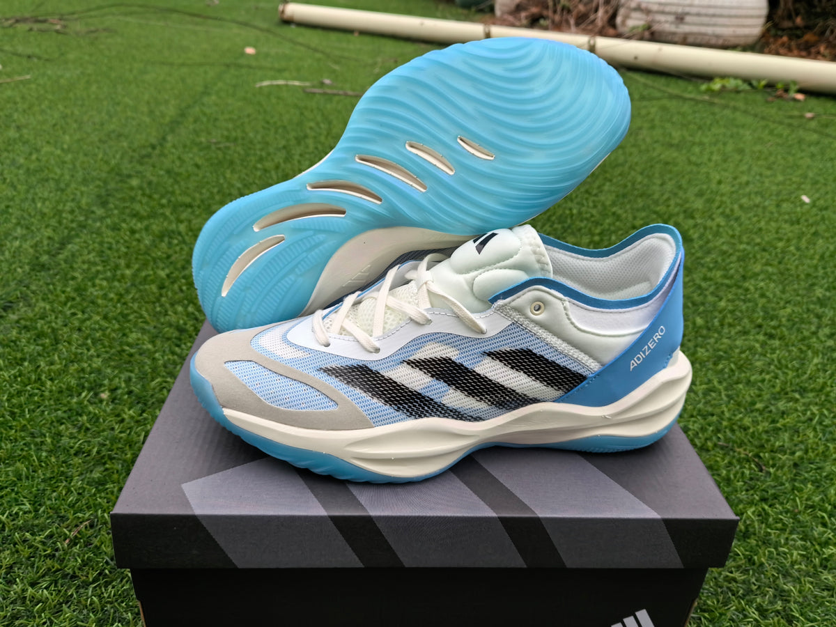 Adidas Adizero white and blue shoes shown on a box with the blue outsole visible.