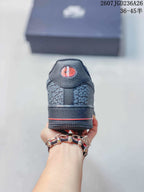 Rear view showing the patterned heel panels, dark midsole, and red horizontal accent.