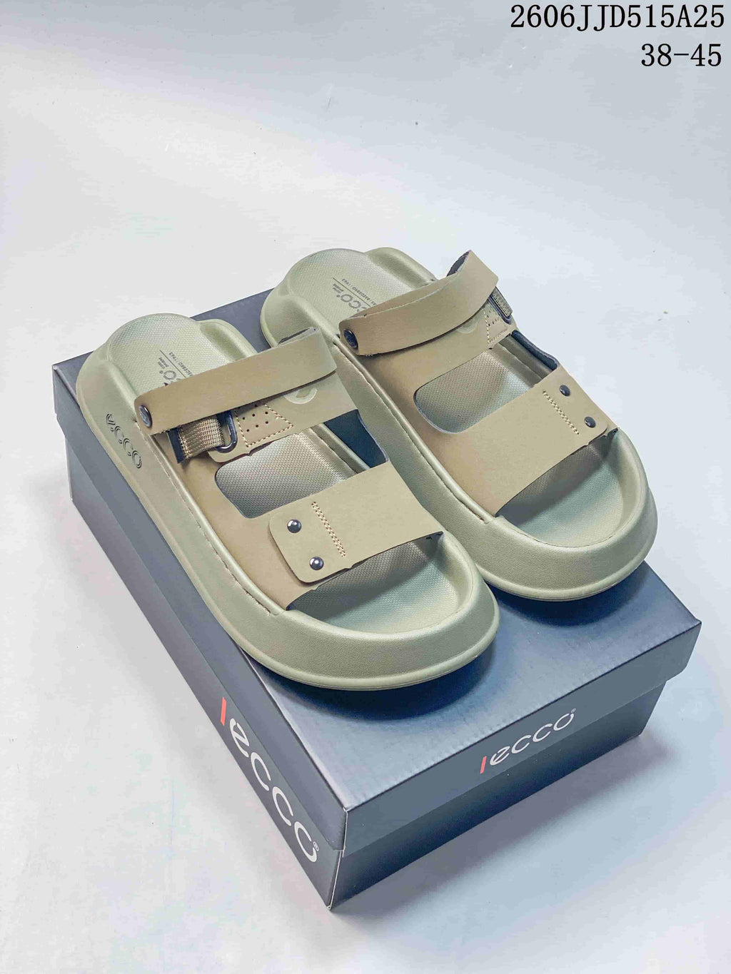 Pair of olive-toned adjustable strap sandals displayed on a box.
