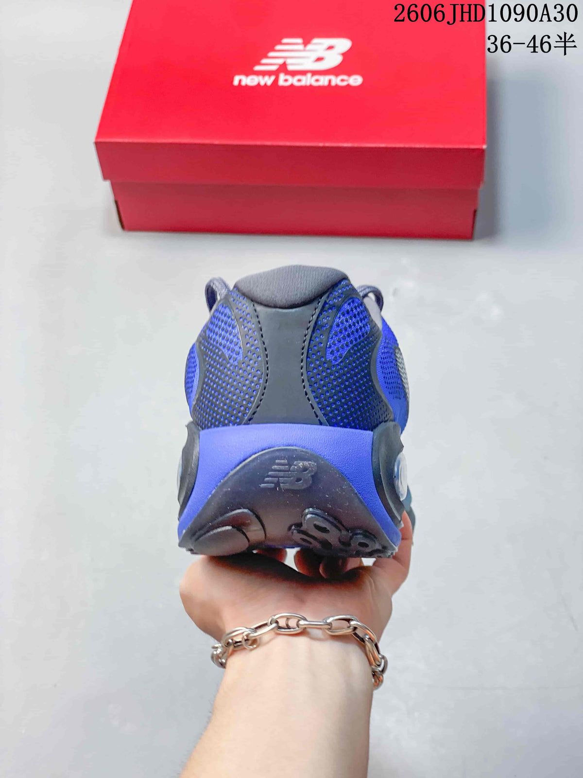 Rear view of the blue and charcoal mesh-look heel and outsole