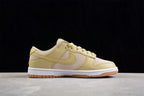 Side profile showing the layered panels, side Swoosh, white midsole, and gum outsole