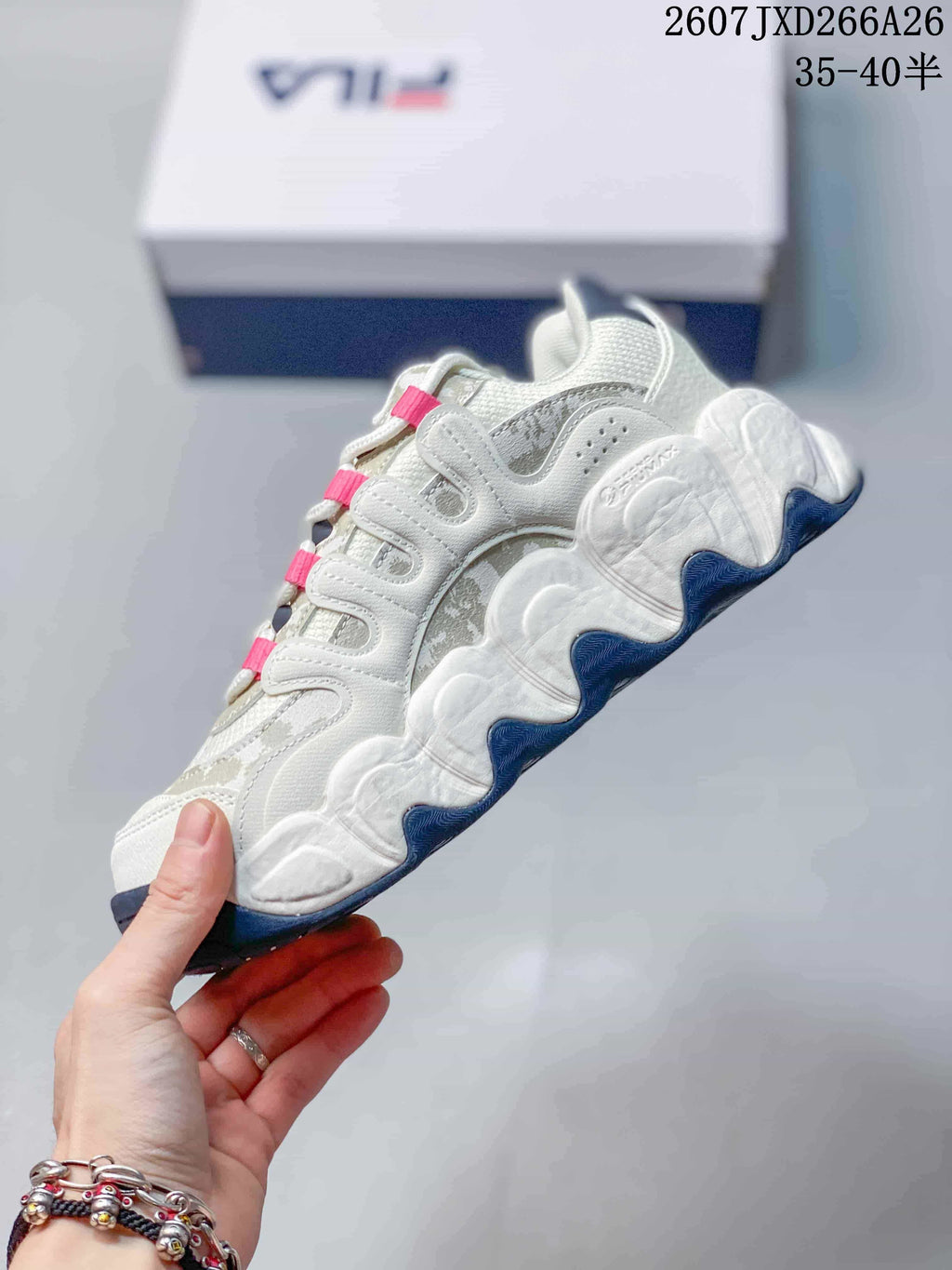 Side view of the white and gray low-top sneaker showing layered panels, sculpted sole sections, and dark blue outsole details.