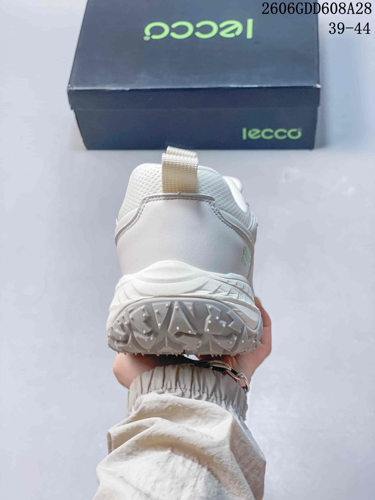 Rear view of the white sneaker showing the heel and outsole.