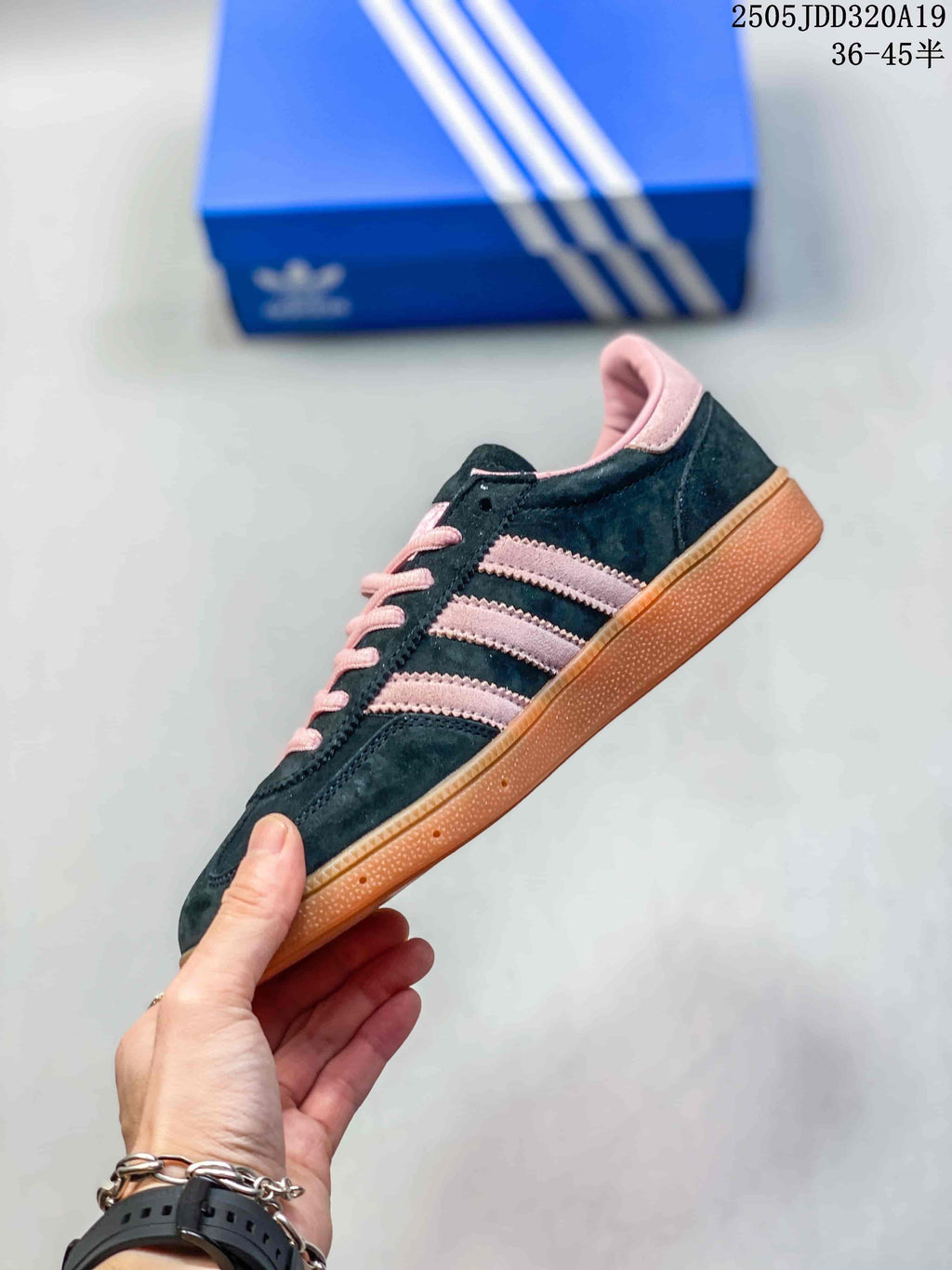 Side view showing the black upper, pink three stripes, pink collar, and gum-colored sole.