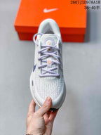 Top view of the white and lavender Nike Journey Run sneaker showing the laces, patterned upper and rounded toe.
