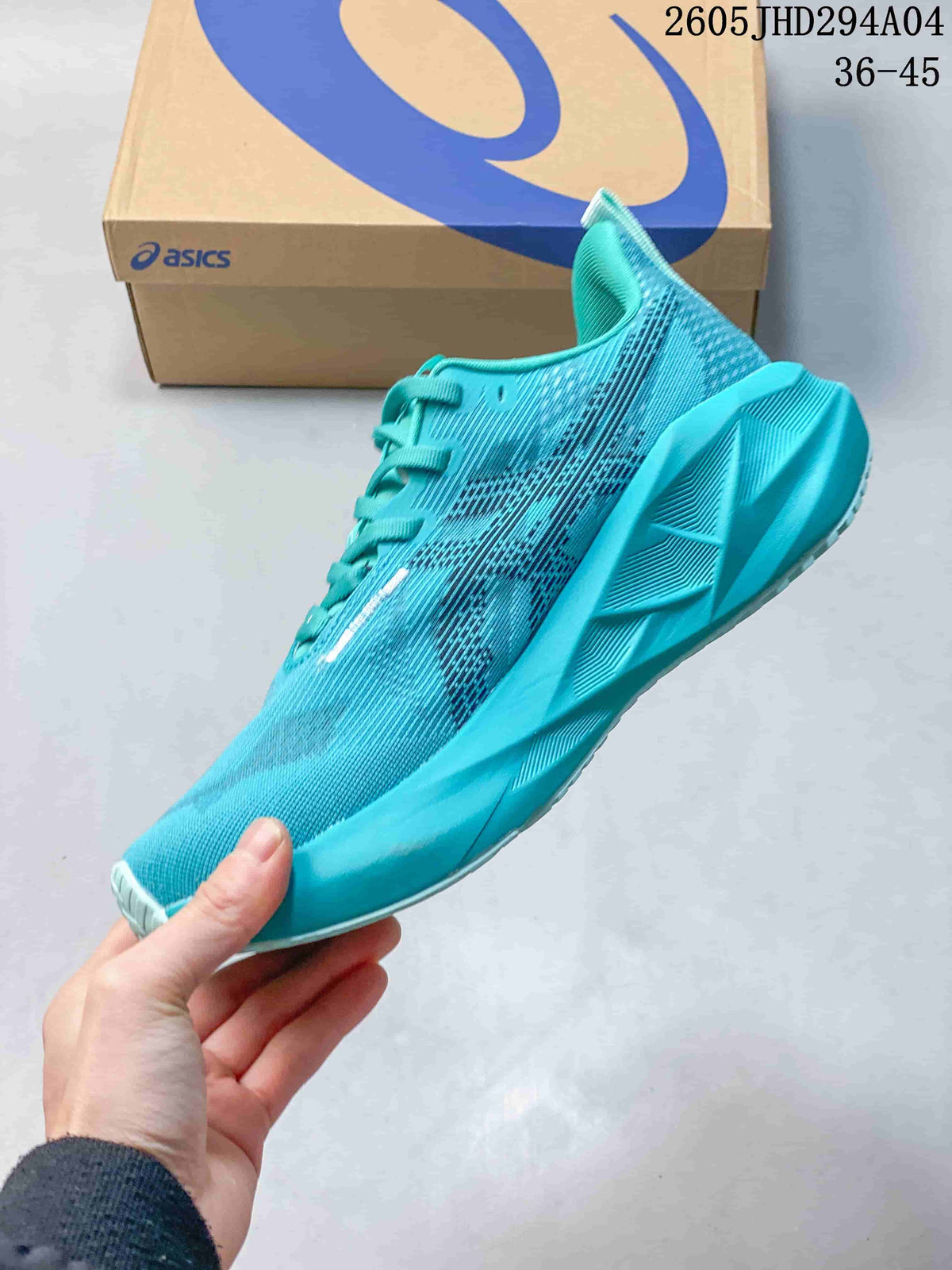 Side view of a turquoise running shoe with a patterned upper and sculpted sole