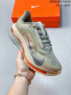 Angled side view of the olive-grey running shoe with dark overlays and orange accents.