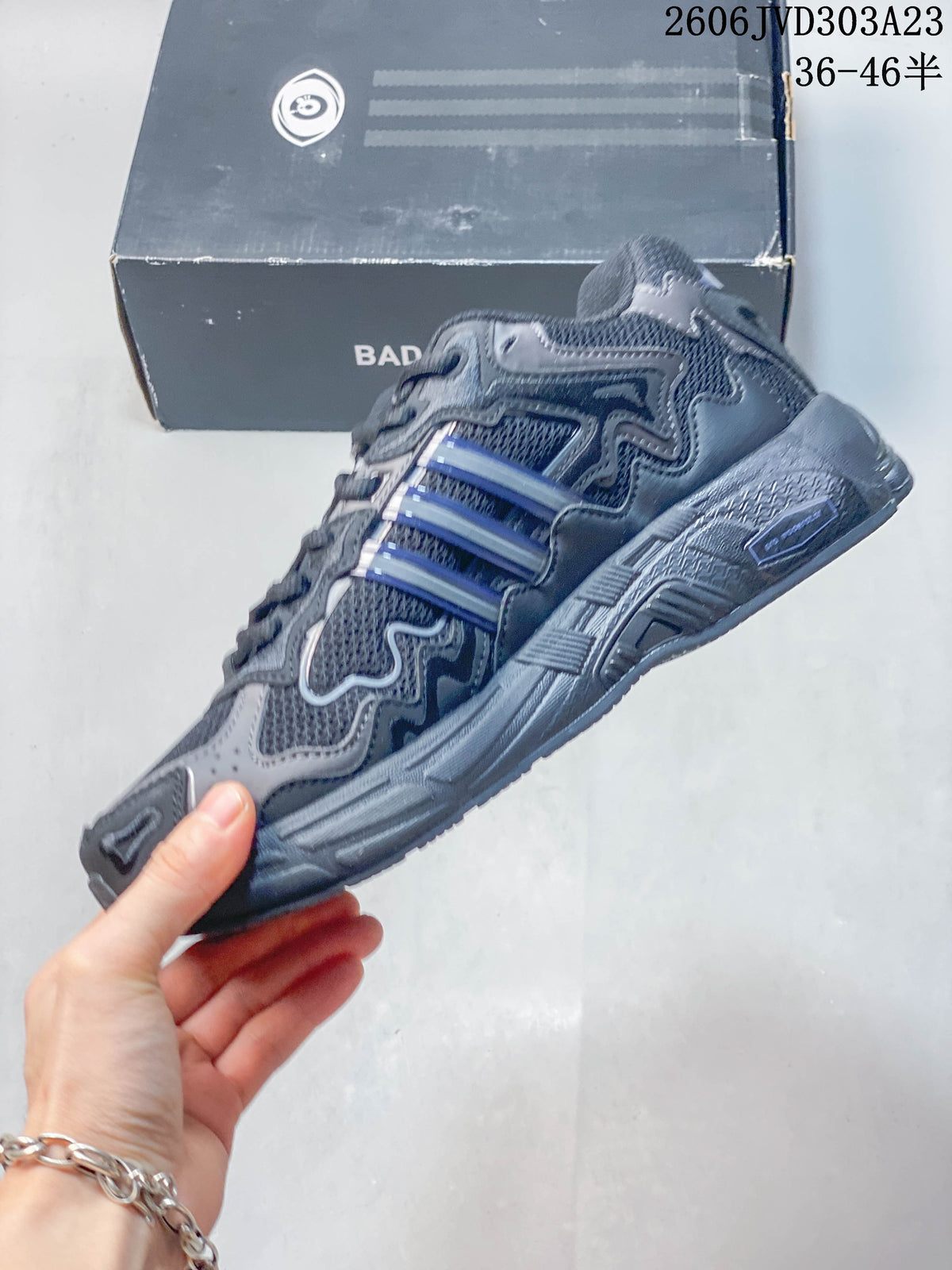 Side view of a grey adidas Response CL sneaker with blue-accented stripes