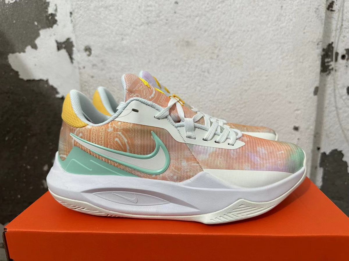 Side view of a pastel multicolor Nike basketball shoe with a mint-green Swoosh and white sole.