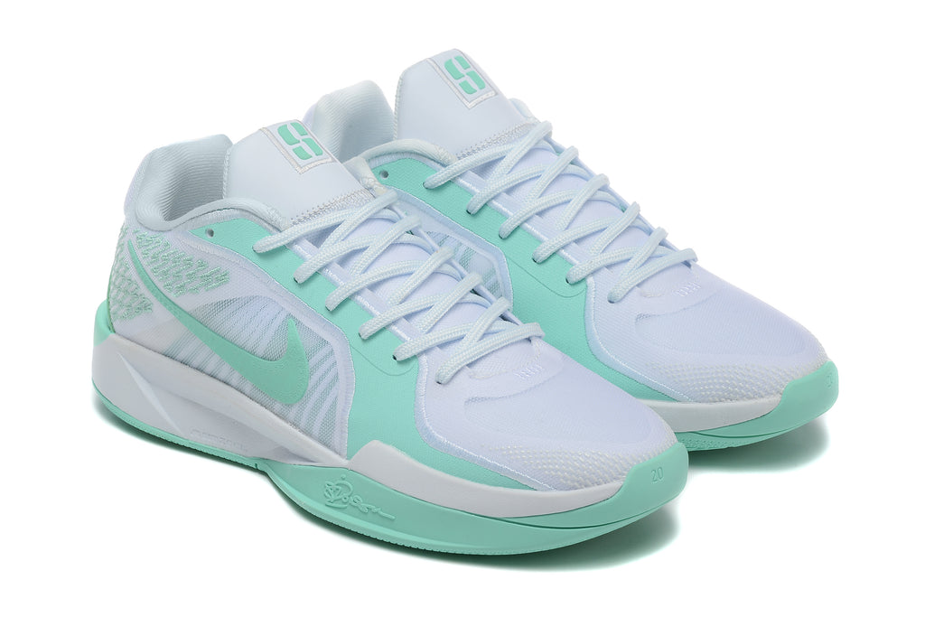 Angled view of a pair of white and mint-green Nike Sabrina basketball shoes