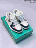 Pair of white and dark navy Nike SB Dunk Low sneakers displayed on a green presentation box.