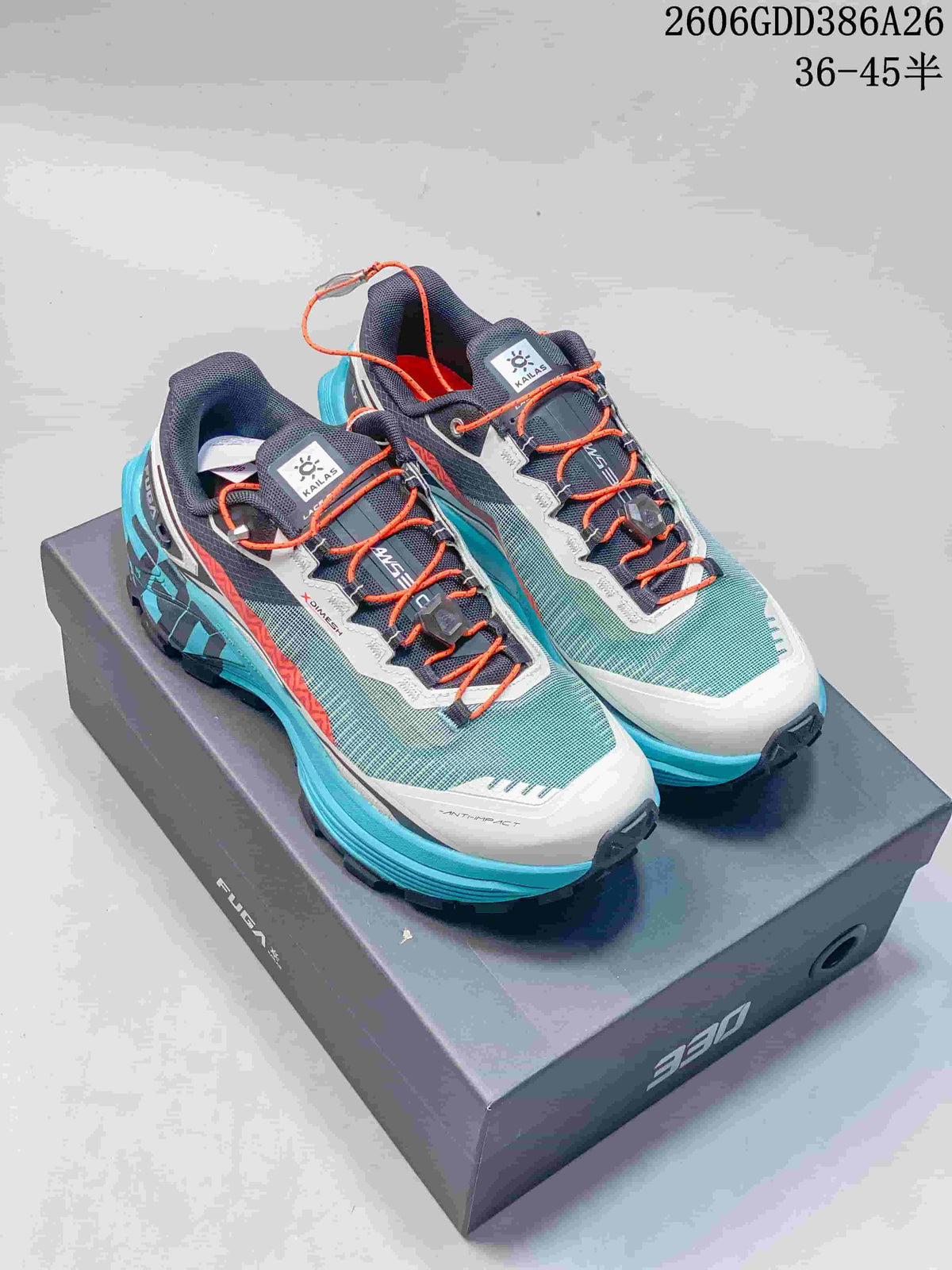 Pair of turquoise, white, navy, and orange Kailas FUGA EX330 trail running shoes on a box