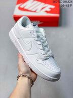 Angled side view of a white Nike low-top sneaker with perforated toe box and layered side panels.