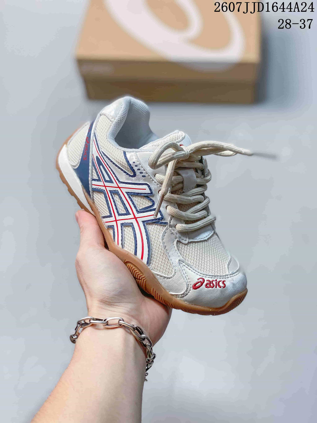 Angled side view of the white, blue and red ASICS HYPERSYNC sneaker.