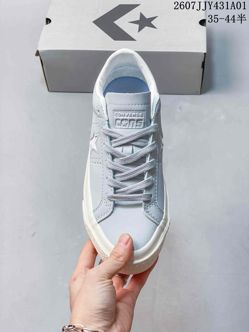 Top view of the laces, tongue, and pale gray-blue upper